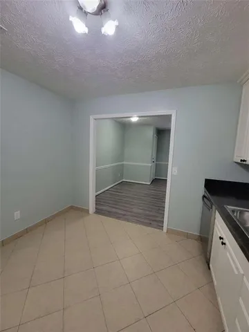 an empty room with fireplace and windows