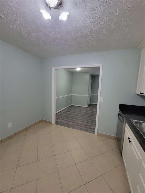 4648 Pine Tree Circle, Unit B Buford, GA 30518 - Photo 8 of 19 an empty room with fireplace and windows