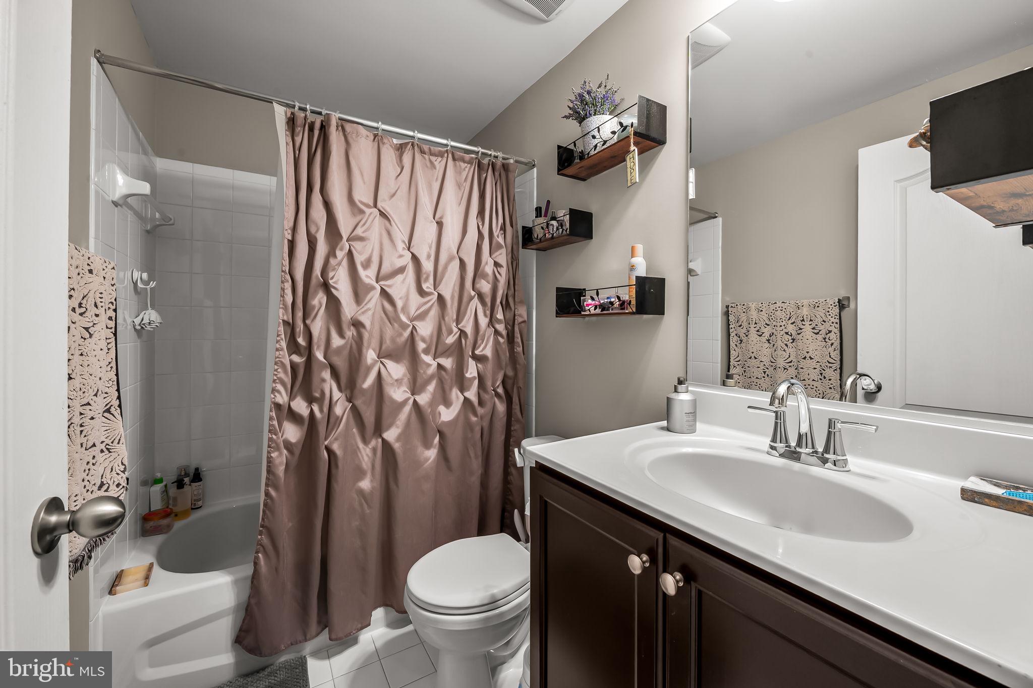 6008 Hanover Road Elkridge, MD 21075 - Photo 29 of 36 a bathroom with a sink vanity mirror and toilet