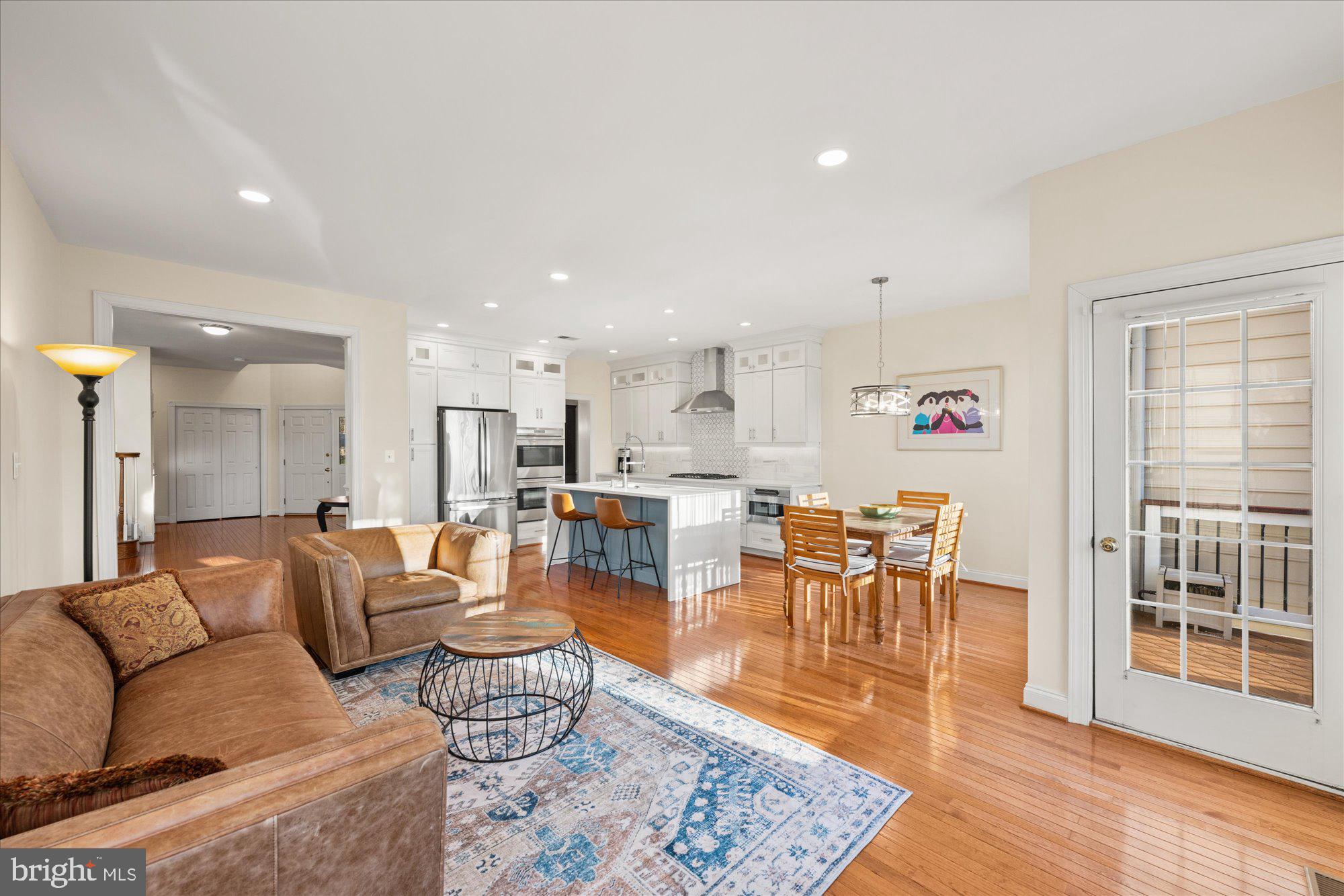 20026 Valhalla Square Ashburn, VA 20147 - Photo 79 of 82 a living room with furniture and a dining table with wooden floor