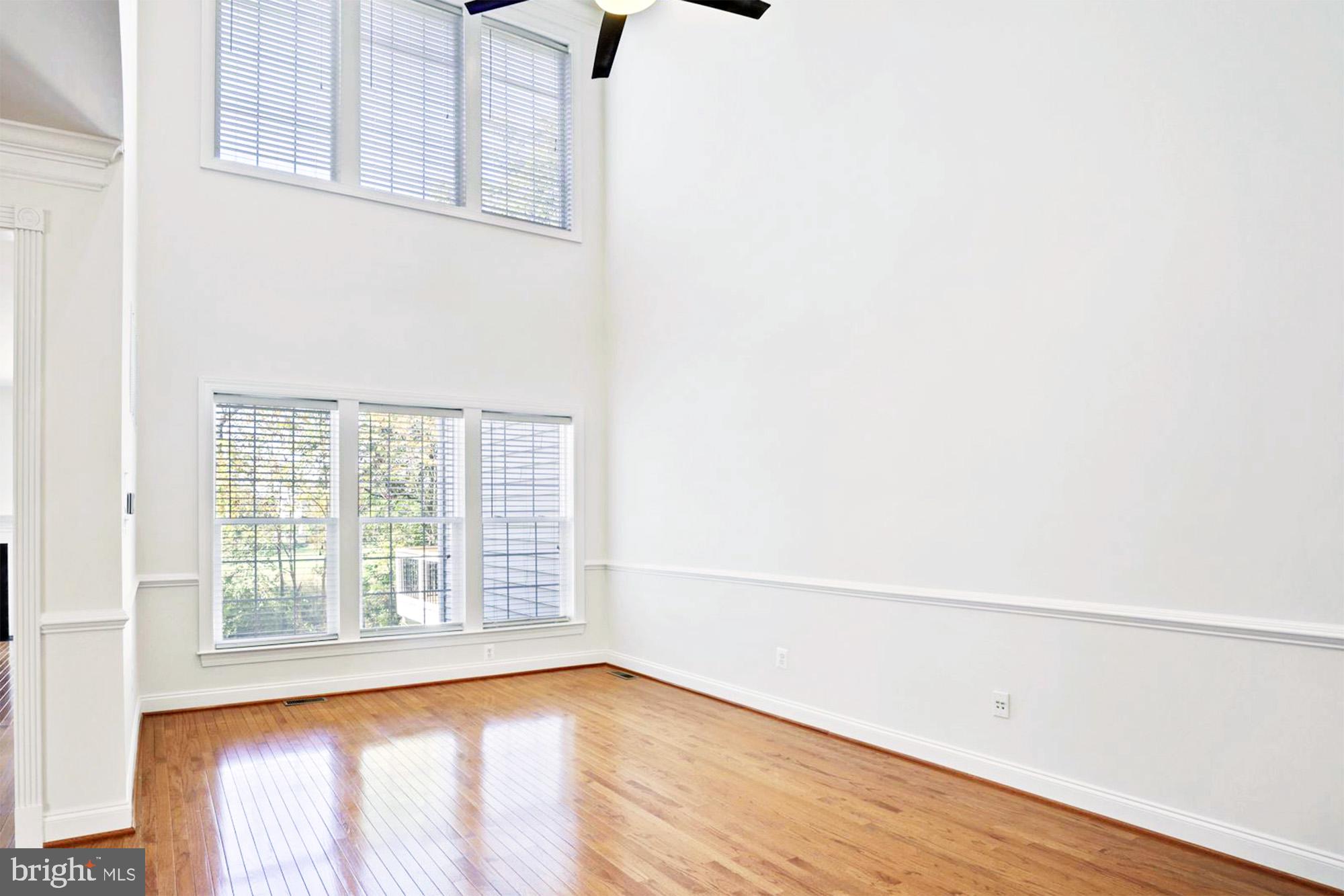 20026 Valhalla Square Ashburn, VA 20147 - Photo 8 of 82 a view of an empty room with wooden floor and a window