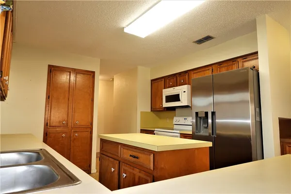 a kitchen with a refrigerator sink and microwave