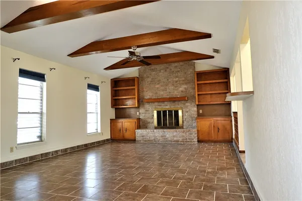 a view of living room with furniture and fireplace