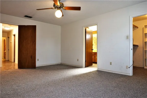 an empty room with windows and closet