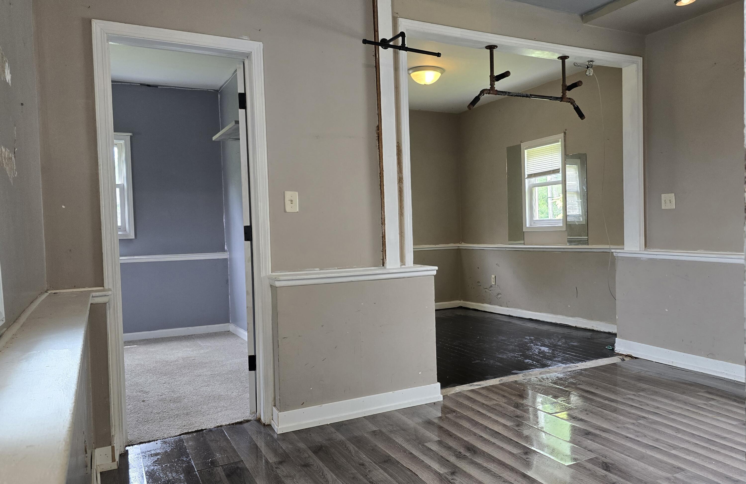 2207 North County Line Road Portage, IN 46368 - Photo 11 of 16 an empty room with wooden floor and windows