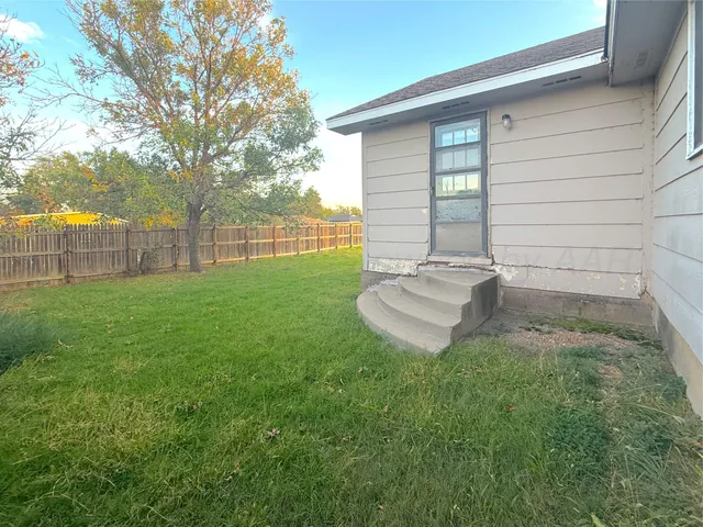 a view of a backyard with a small cabin