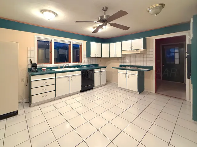 a kitchen with stainless steel appliances granite countertop a sink and cabinets