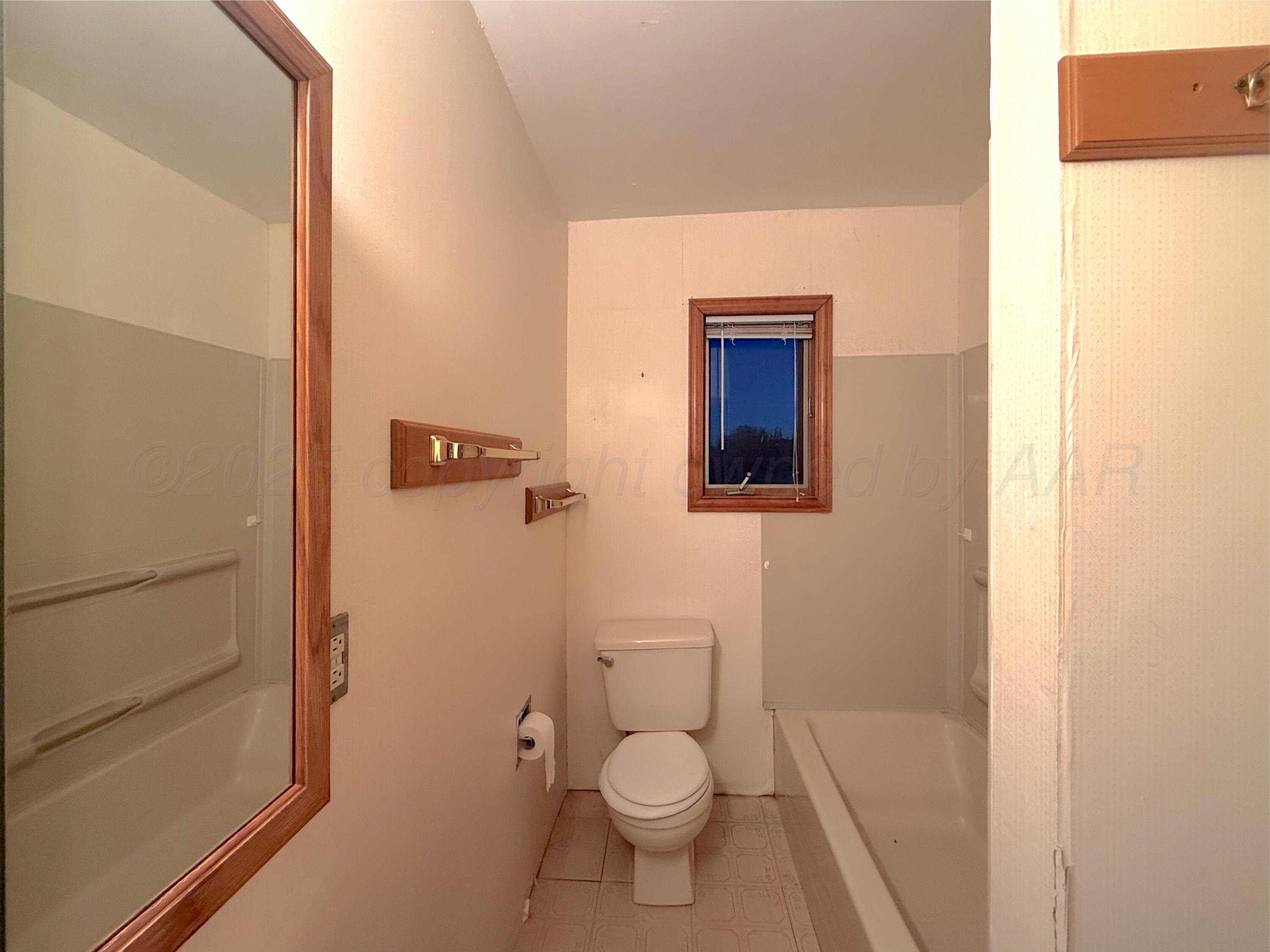 301 West 10th Street Stinnett, TX 79083 - Photo 10 of 15 a bathroom with a toilet