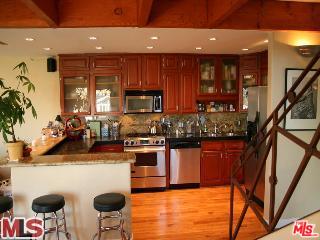 33 Reef Street, Unit 1 Marina del Rey, CA 90292 - Photo 5 of 7 a kitchen with stainless steel appliances granite countertop a refrigerator a stove top oven a sink and dishwasher