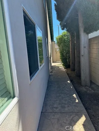 a view of a pathway of a house with plants