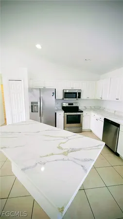 a kitchen with a stove a refrigerator and a sink