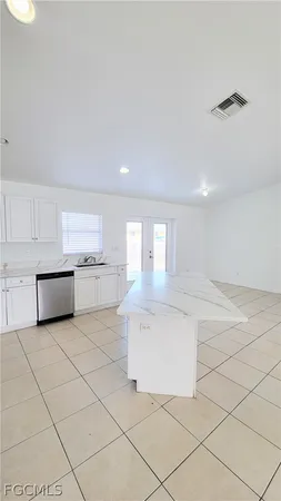 a kitchen with white cabinets and white appliances