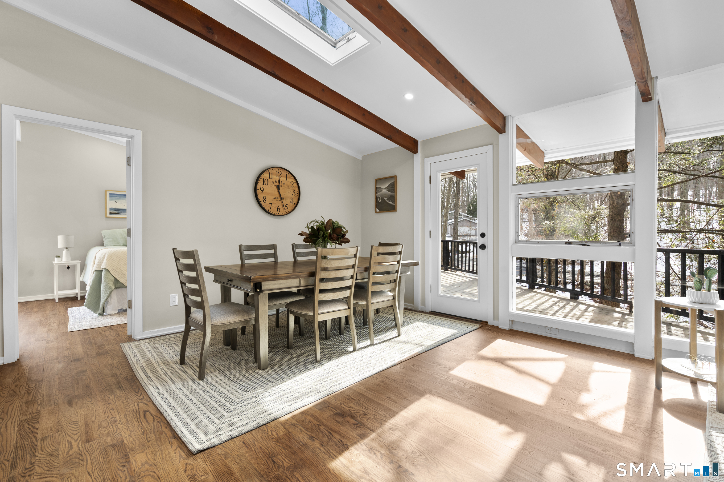 143 Gaylord Mountain Road Bethany, CT 06524 - Photo 11 of 30 a view of a dining room and livingroom with furniture wooden floor and a rug