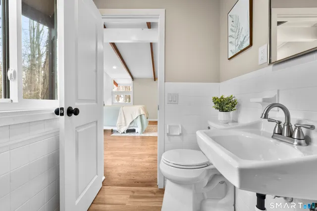 a bathroom with a toilet sink and mirror
