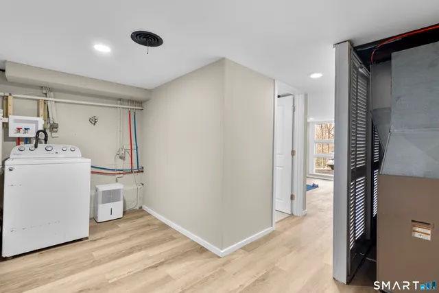 a roof deck with table and chairs and wooden floor
