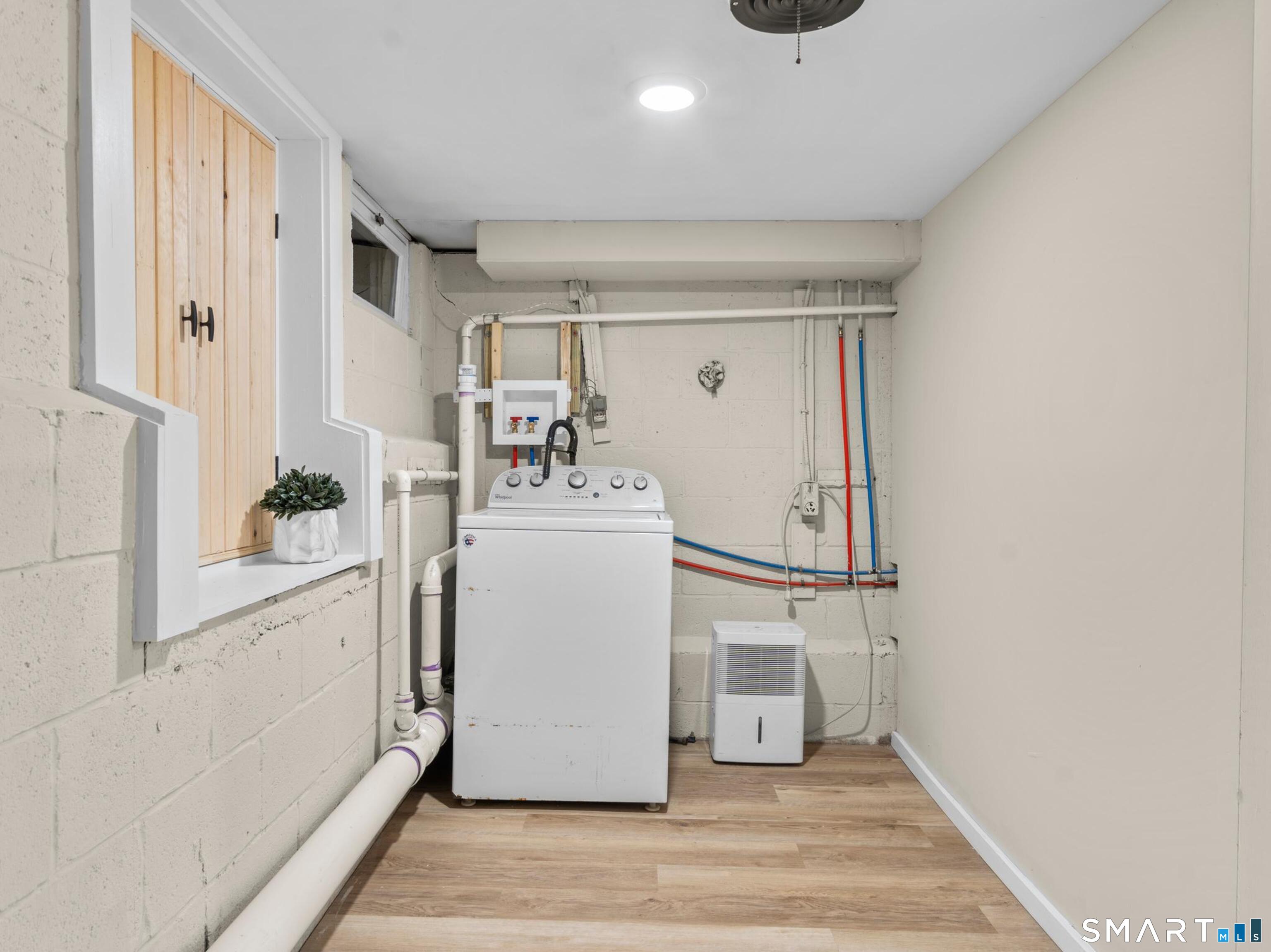 143 Gaylord Mountain Road Bethany, CT 06524 - Photo 20 of 30 a utility room with cabinets washer and dryer