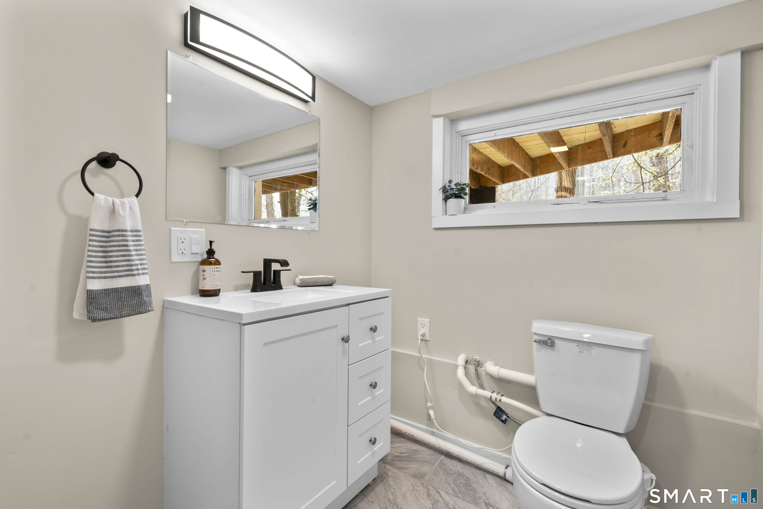 143 Gaylord Mountain Road Bethany, CT 06524 - Photo 21 of 30 a bathroom with a toilet sink and mirror