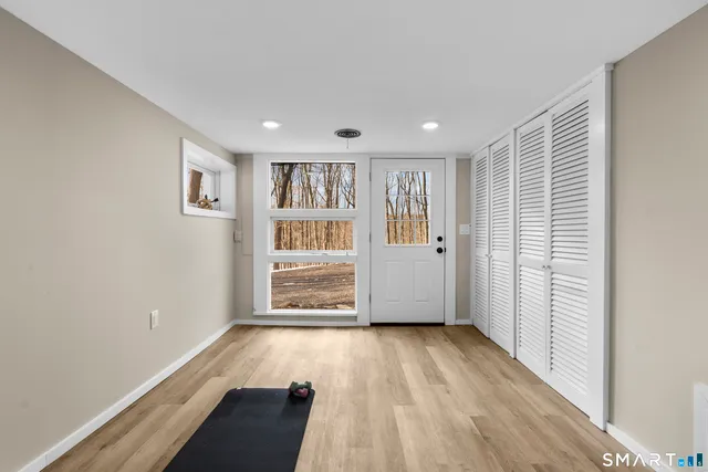 a backyard of a house with a large tree