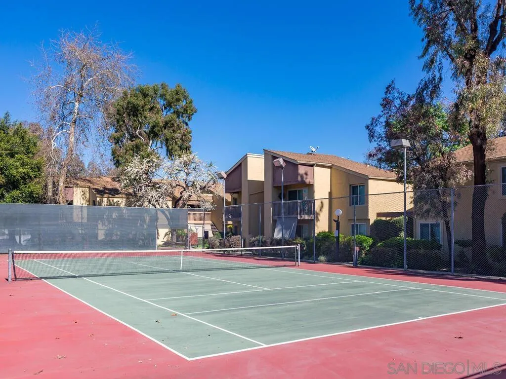 5950 Rancho Mission Road, Unit 166 San Diego, CA 92108 - Photo 13 of 18 a view of a tennis ground with large trees