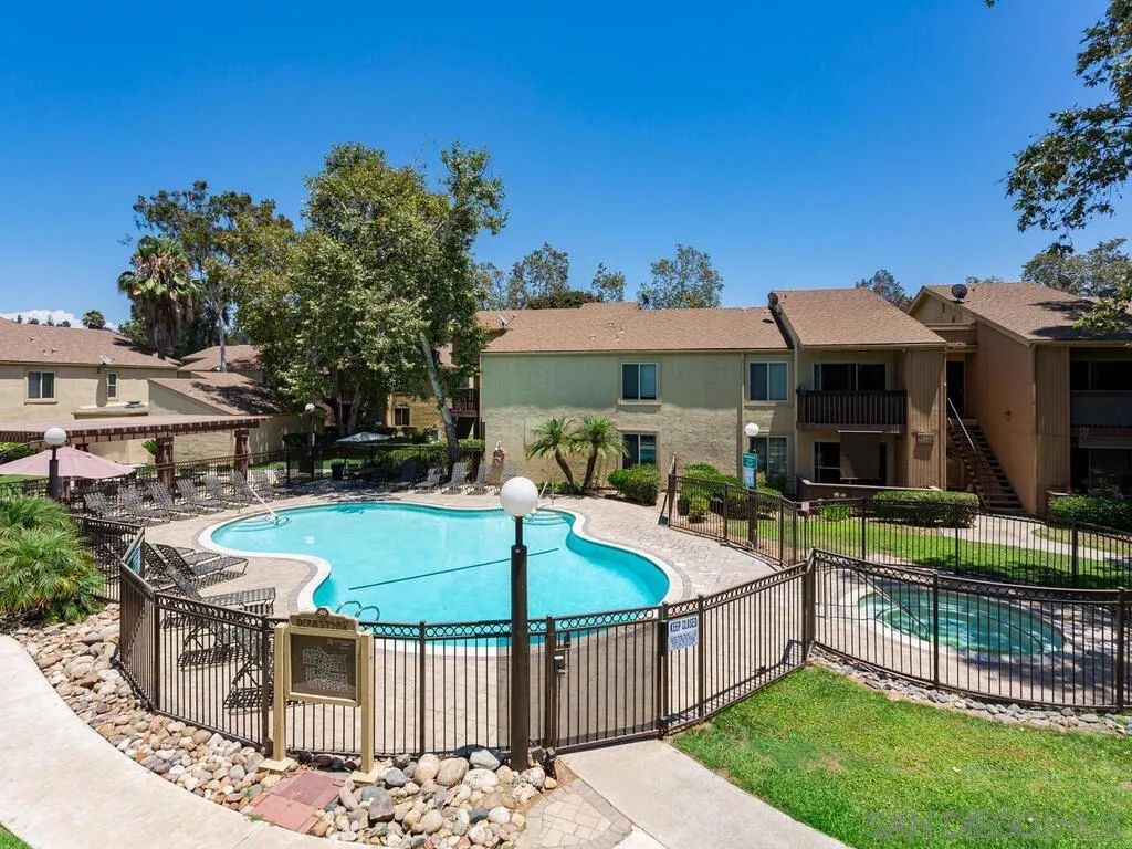 5950 Rancho Mission Road, Unit 166 San Diego, CA 92108 - Photo 2 of 18 an outdoor space with furniture and umbrella