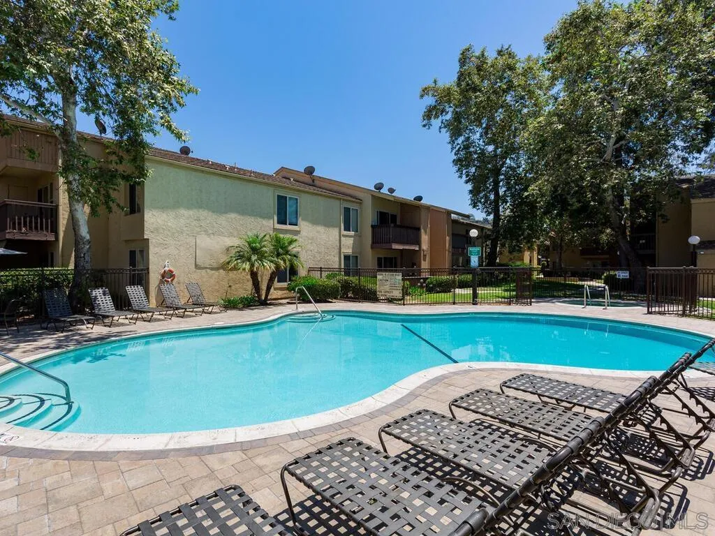 5950 Rancho Mission Road, Unit 166 San Diego, CA 92108 - Photo 6 of 18 a view of a swimming pool with a lounge chairs