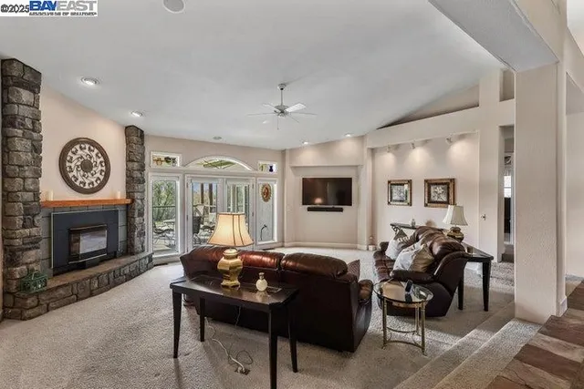 a living room with a clock and a fireplace