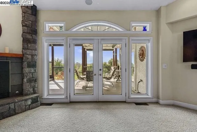 a living room with furniture and a glass door