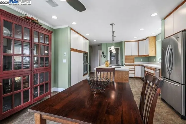 a utility room with cabinets washer and dryer