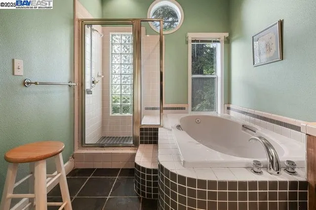 a view of a green field with a tree in a yard