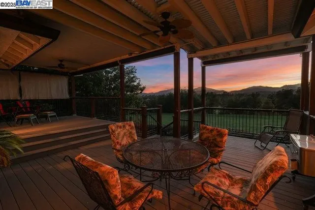 an aerial view of a city with lots of residential buildings and mountain view in back