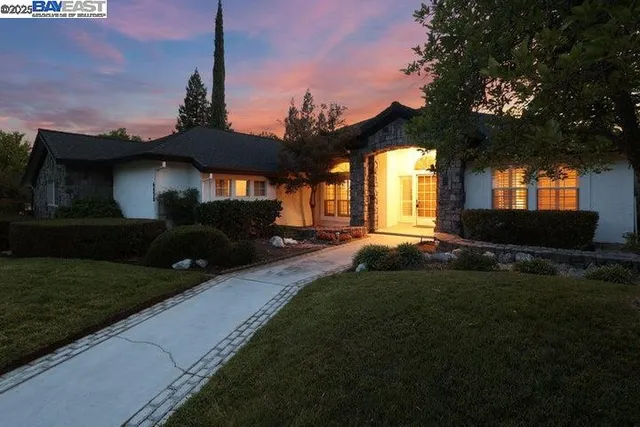 an aerial view of green landscape with trees houses and mountain view