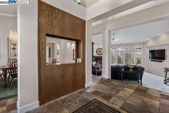 a view of a dining room and livingroom with furniture window and wooden floor