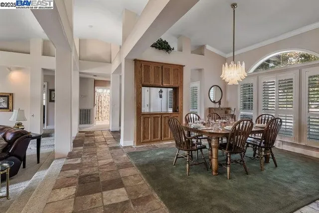 a living room with furniture a clock and a fireplace