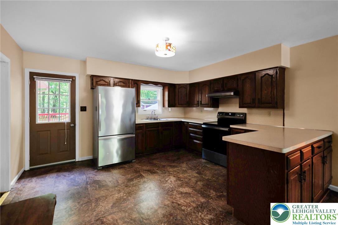 256 Sundance Road Effort, PA 18330 - Photo 62 of 83 a kitchen with a refrigerator a microwave a sink and a stove