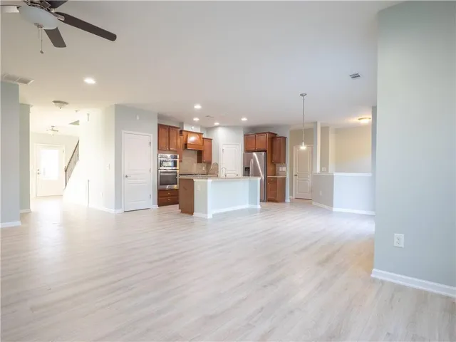 a view of a kitchen with a sink and a refrigerator