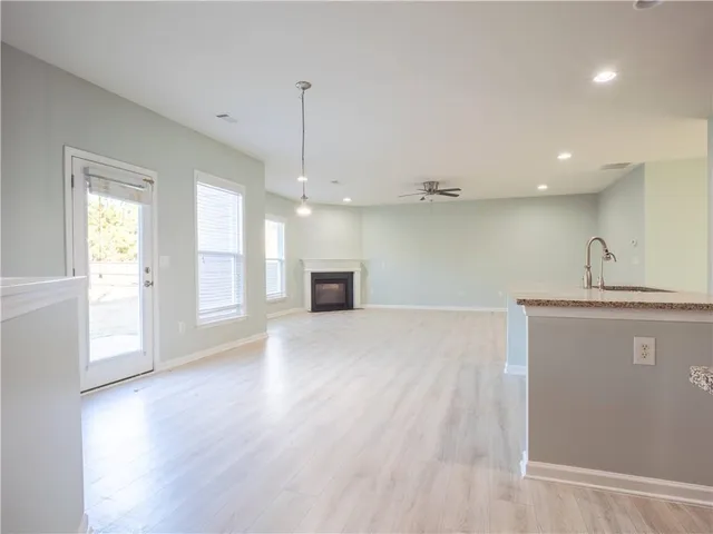 a view of an empty room and window and wooden floor