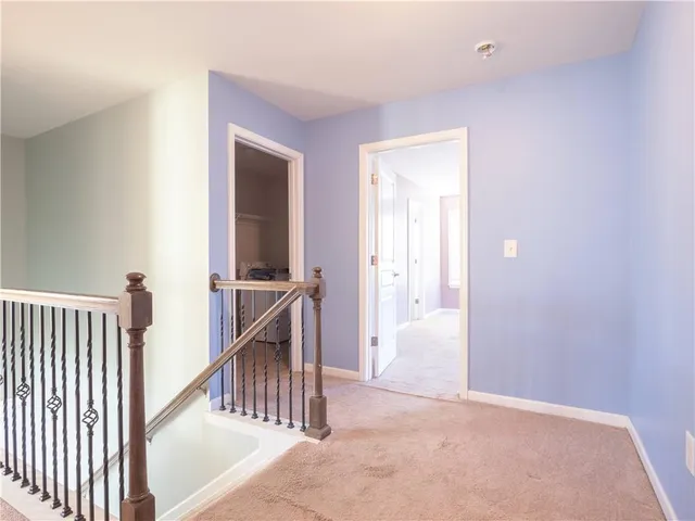 a view of hallway with a window and a bathroom