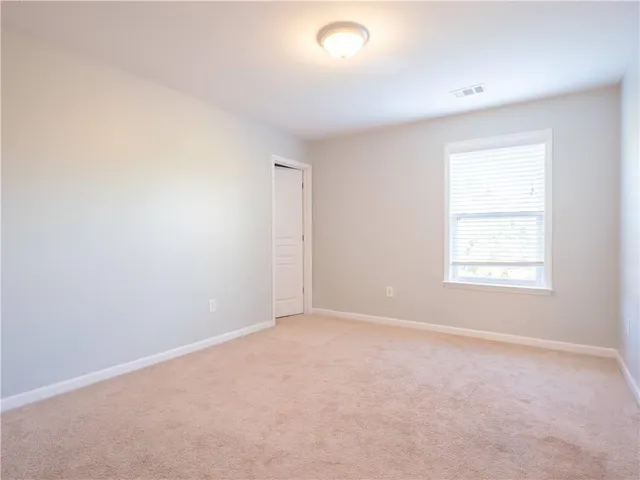 a view of empty room with ceiling fan