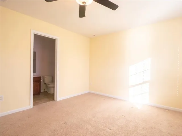 a white toilet sitting next to a bathroom sink