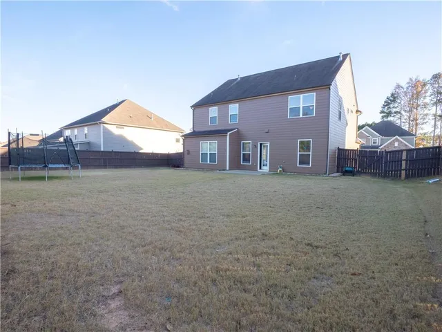 a view of a house with a yard and garage