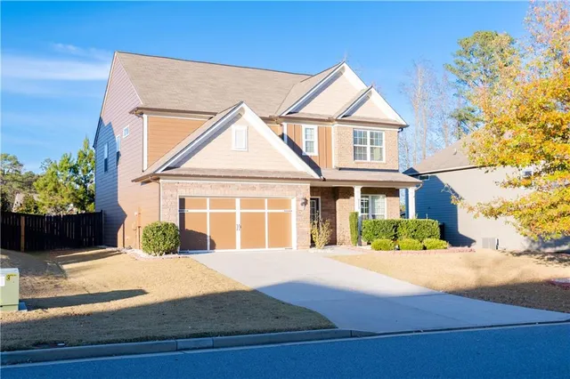 a front view of a house with a yard