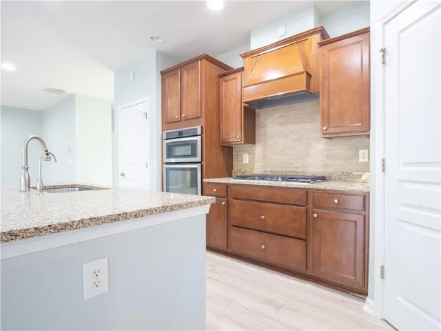 a kitchen with granite countertop a sink and a stove