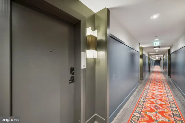 a view of hallway with a ceiling fan