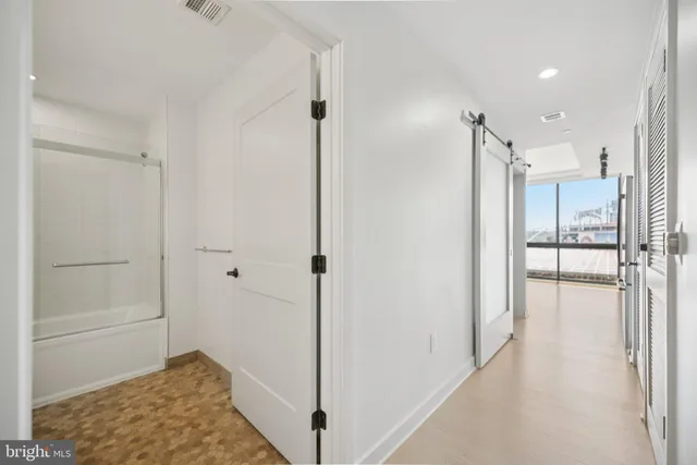 a view of an empty room with windows