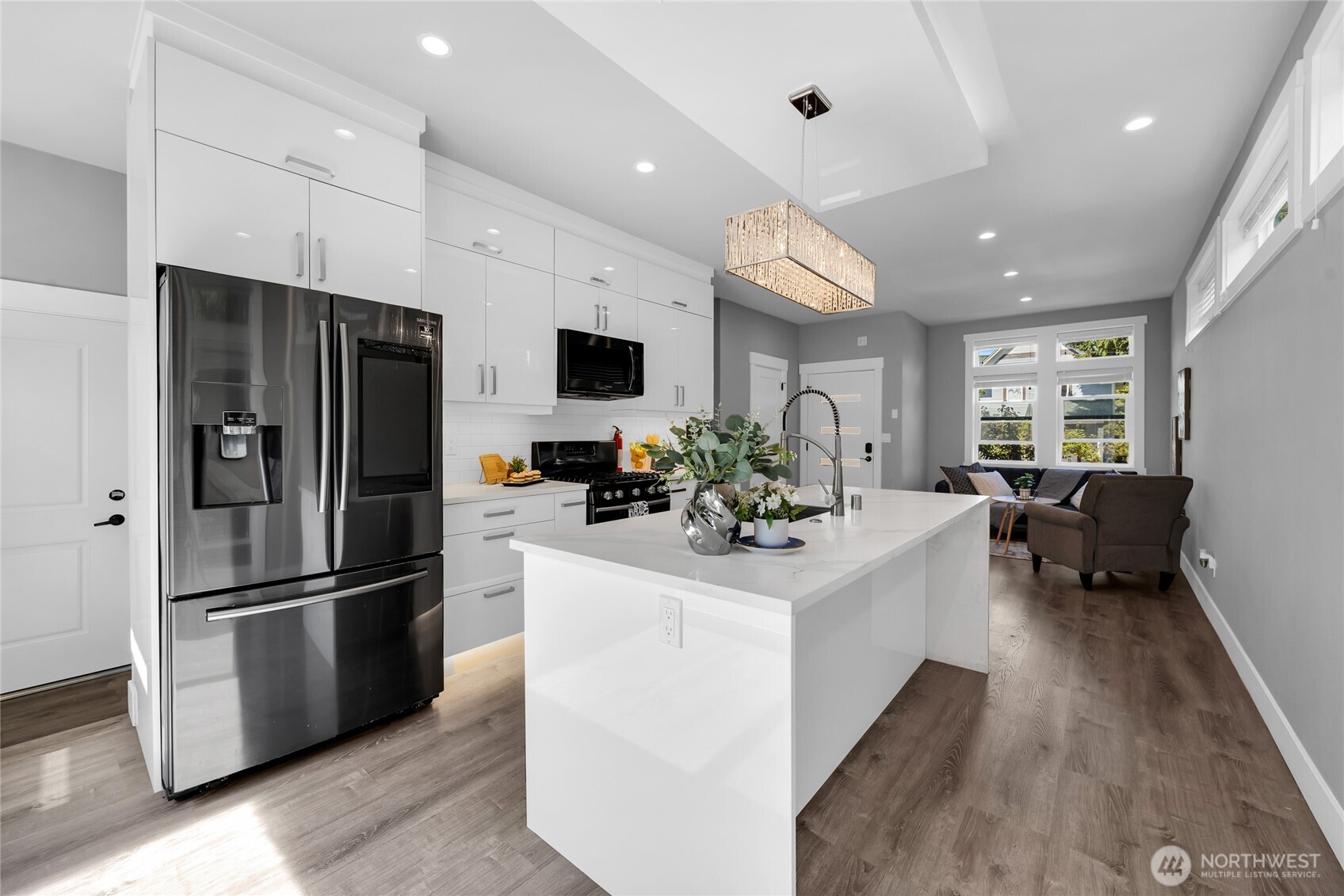 1315 Astor Street Bellingham, WA 98225 - Photo 8 of 34 a kitchen with stainless steel appliances kitchen island granite countertop a refrigerator and a stove top oven