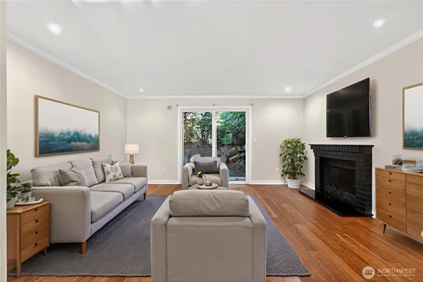 a living room with furniture a fireplace and a flat screen tv