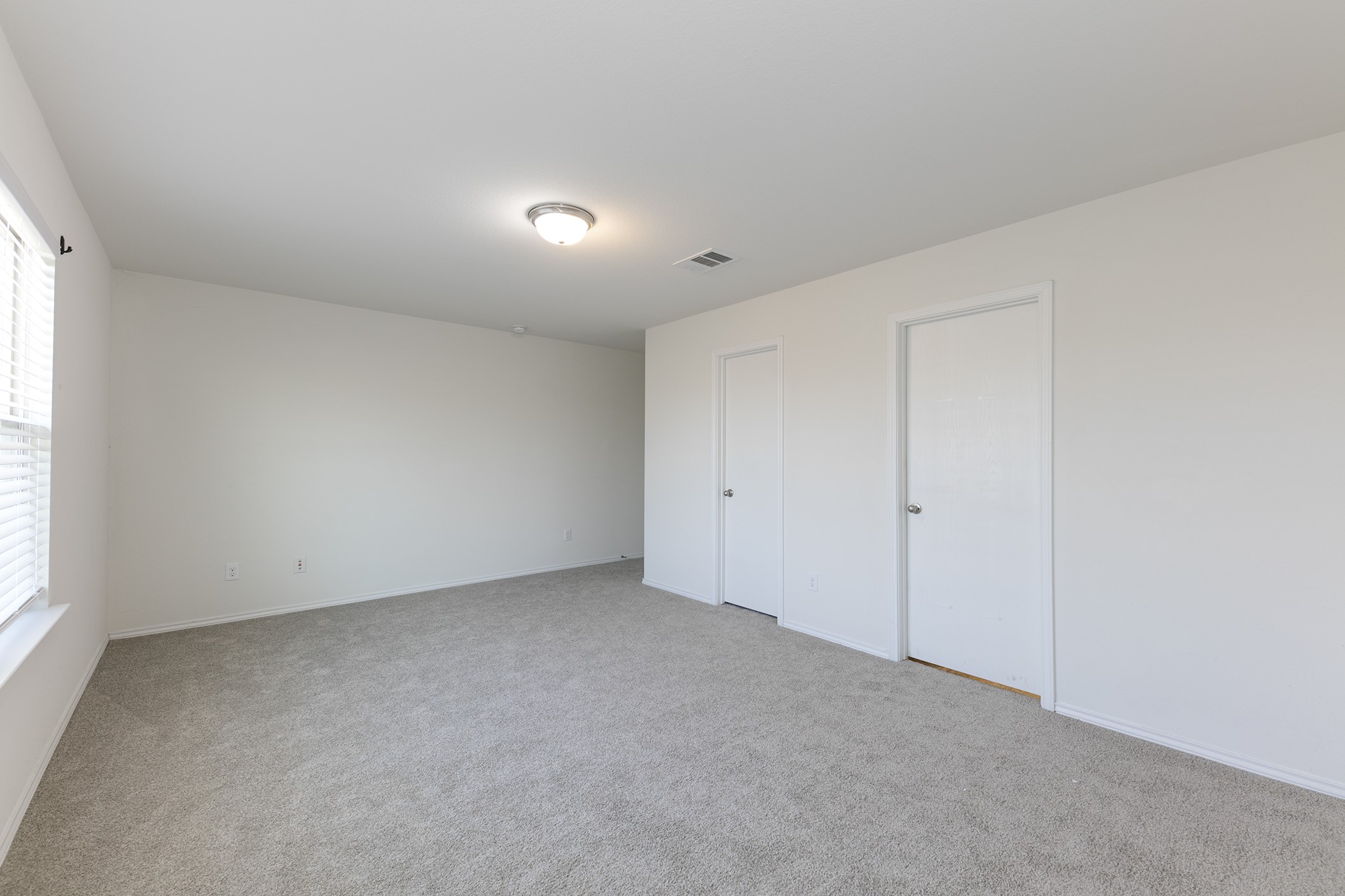 1141 Renaissance Trail Round Rock, TX 78665 - Photo 8 of 23 A spacious room offers comfortable carpet flooring and ample natural light through a generous window.