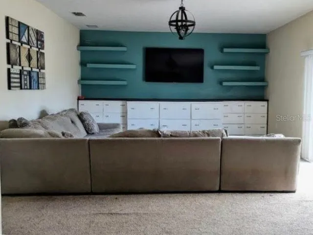 a room with a flat screen tv and a fireplace