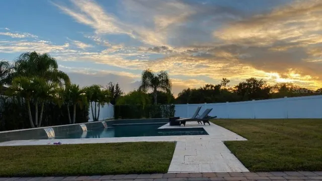 a view of a garden with lawn chairs