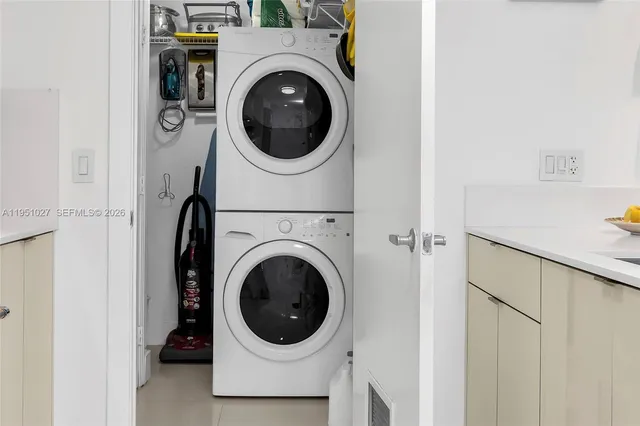 a large kitchen with a sink dishwasher stove and refrigerator with wooden floor